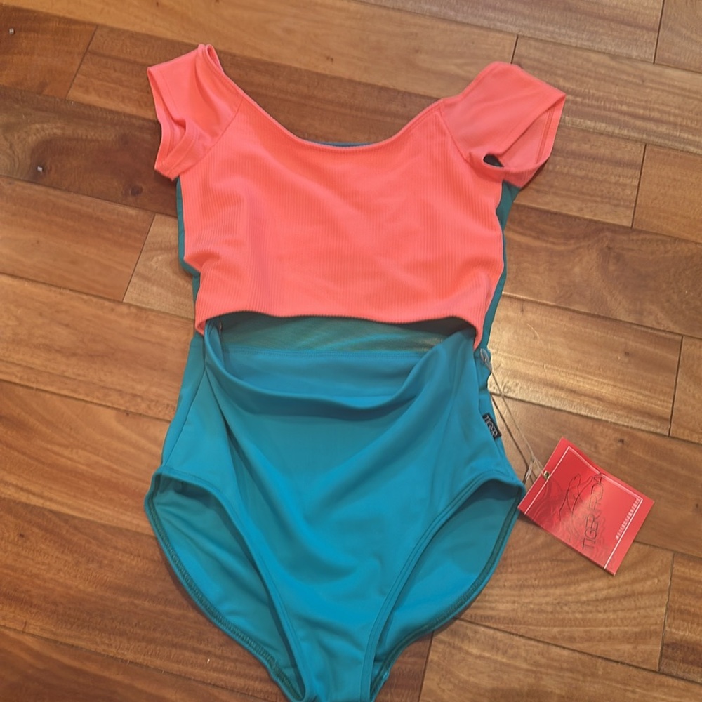 Never Worn! TigerFriday Hepburn Leotard in Coral Reef size AM
Sold out on site
